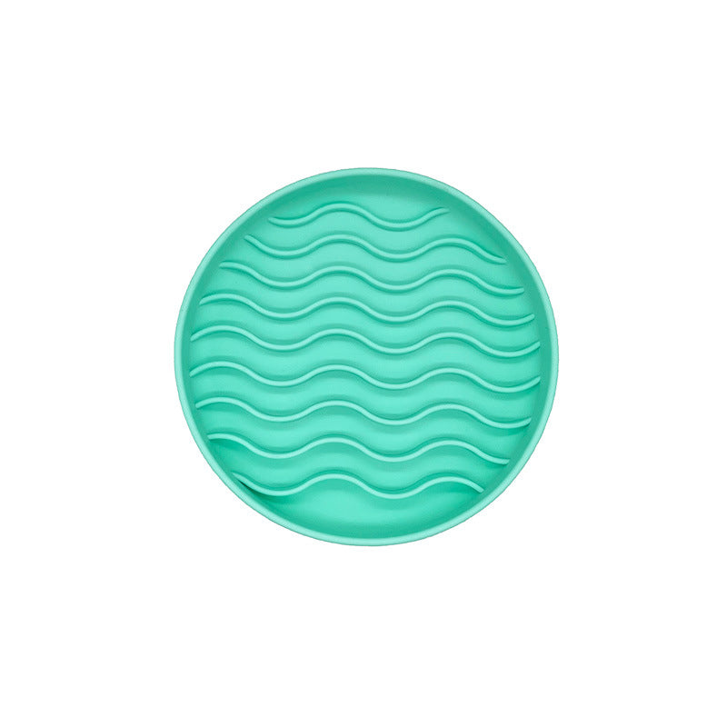 mint green licking bowl on a white background