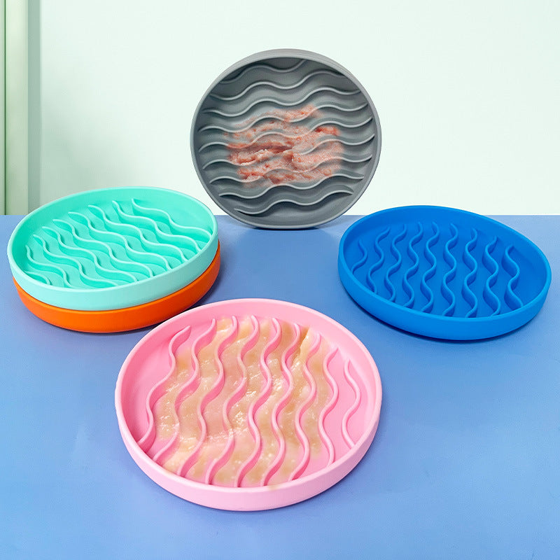 Set of colorful silicone licking mats with wavy pattern on a blue surface