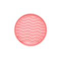 Pink round  licking bowl with wavy pattern on a white background